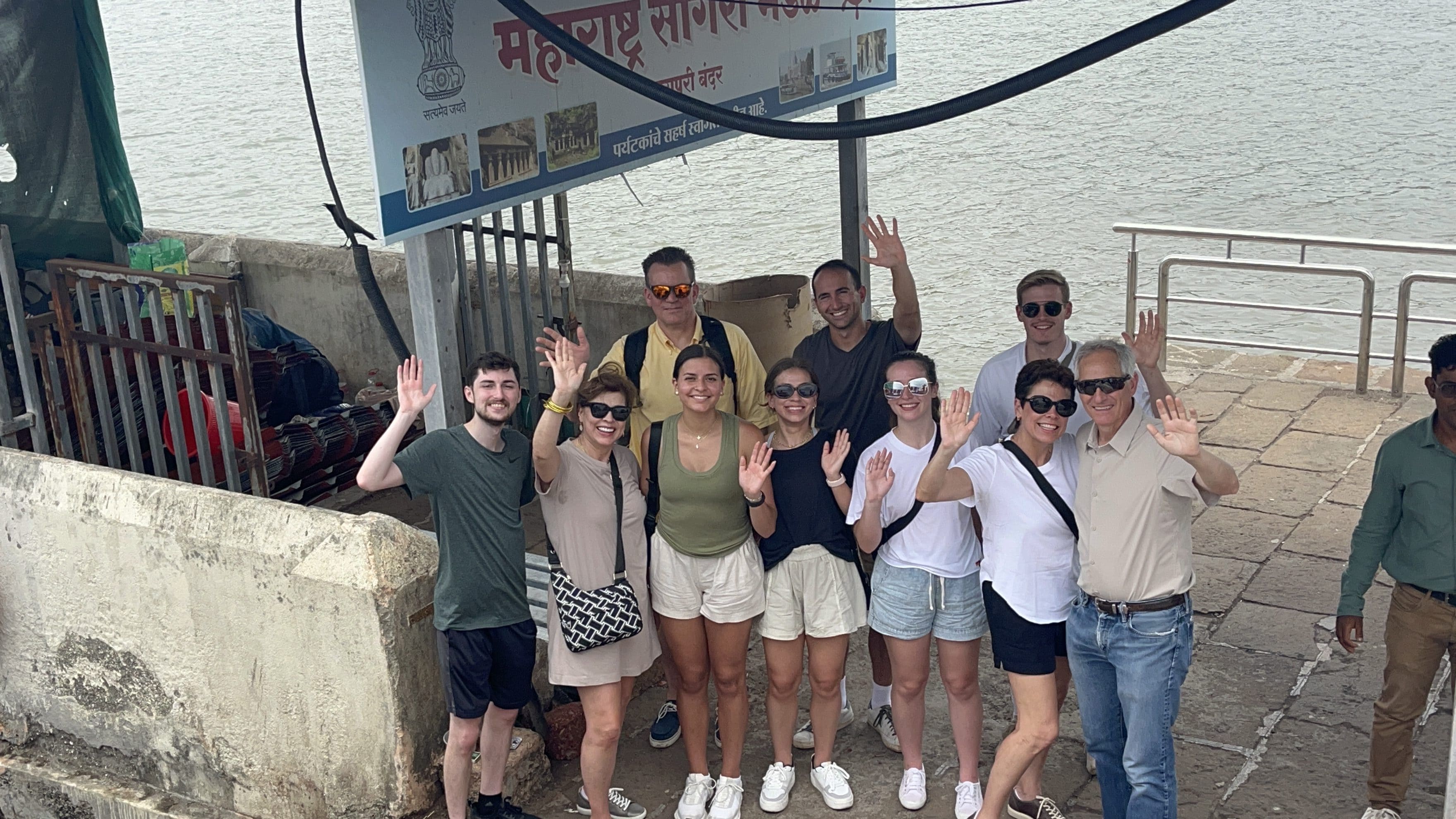 Visitors arriving at Elephanta Island jetty and greeting the camera during a speedboat tour from Mumbai