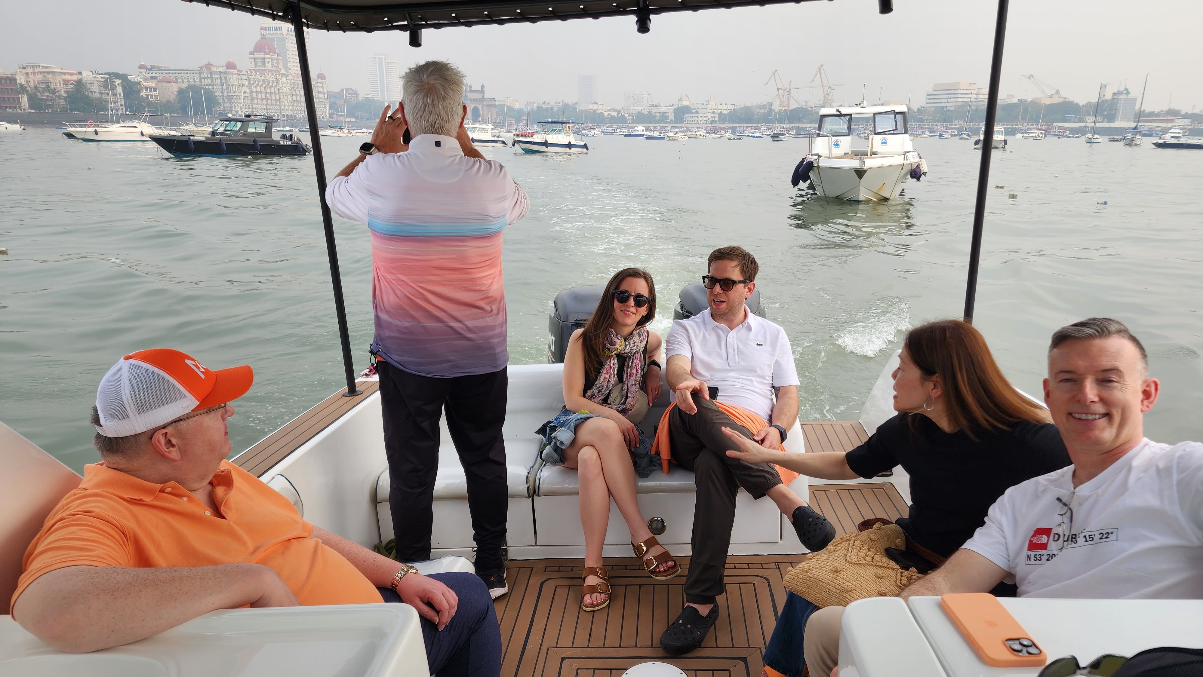 International travelers relaxing on a premium speedboat en route to Elephanta Caves from Mumbai Harbour